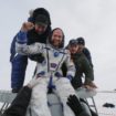 Ground personnel help International Space Station crew member Gerst to get out of a Soyuz capsule after landing near Zhezkazgan