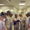 Medical team hold the first baby born via uterus transplant from a deceased donor, at the hospital in Sao Paulo